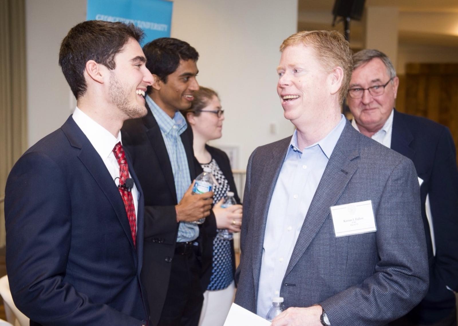 Zachary Kay (F’16) (left) speaks with Kieran J. Fallon (F’88, Parent’19) during the Scholarship Recognition Event in April.