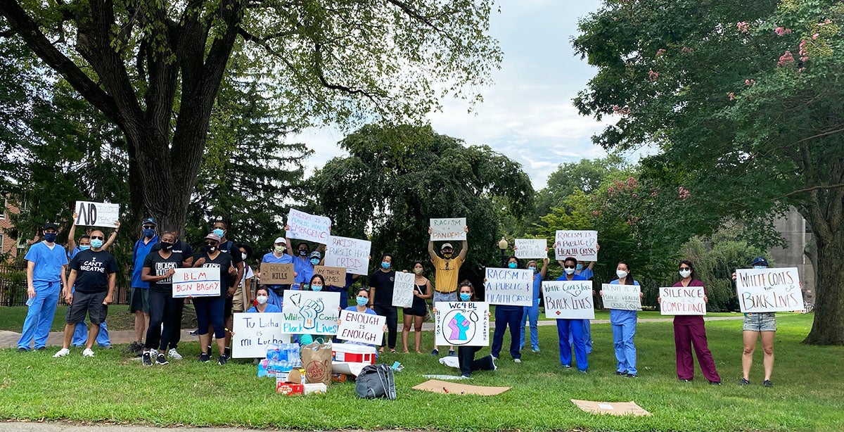 medical students holding protest signs