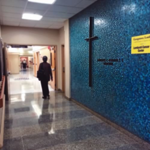 person walking down hallway at catholic hospital