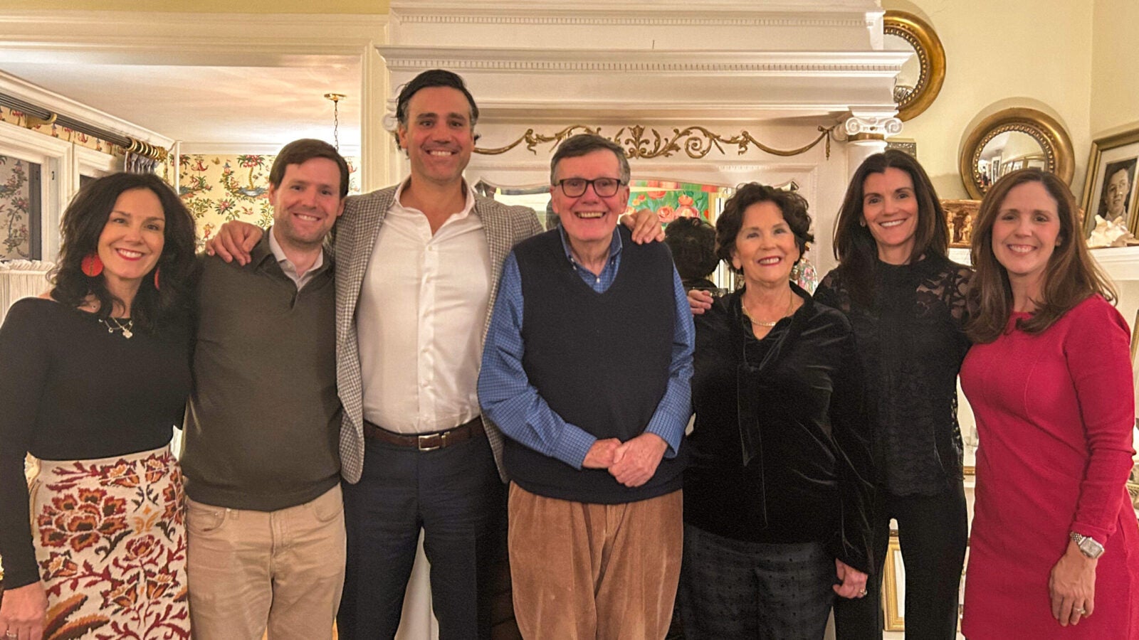 four women and three men stand for a group photo