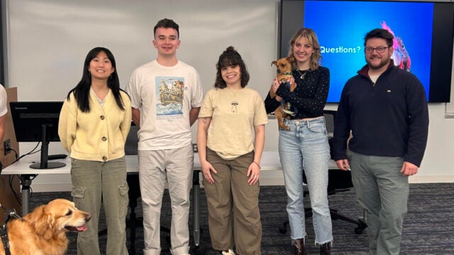 a group of people in a classroom with animals