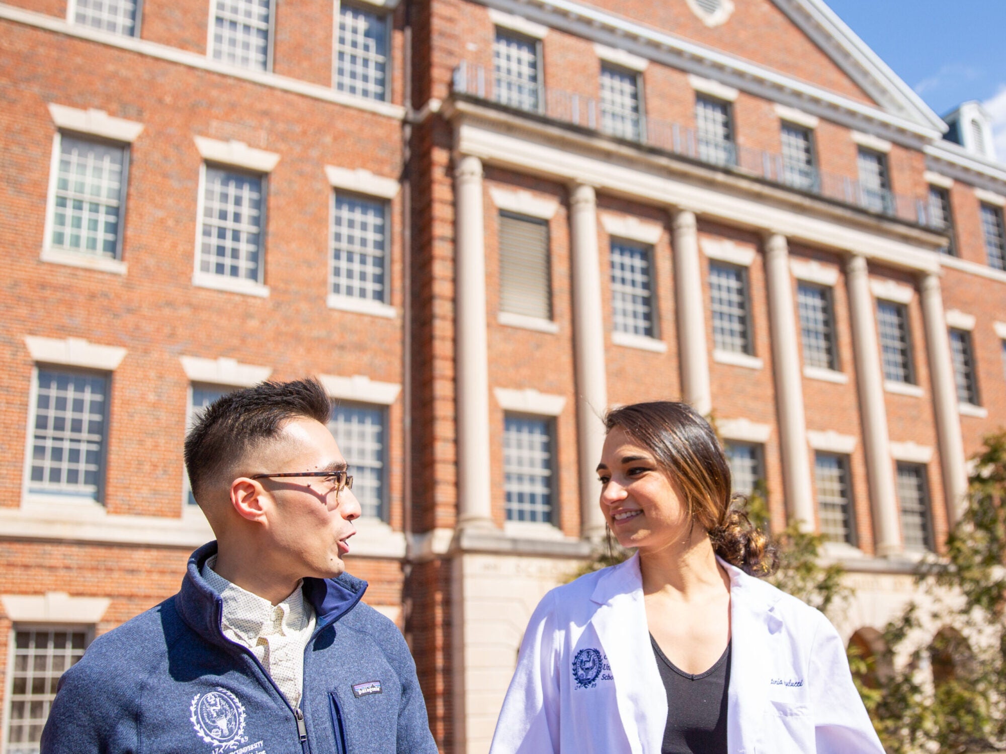 medical students talking in front of medical school building