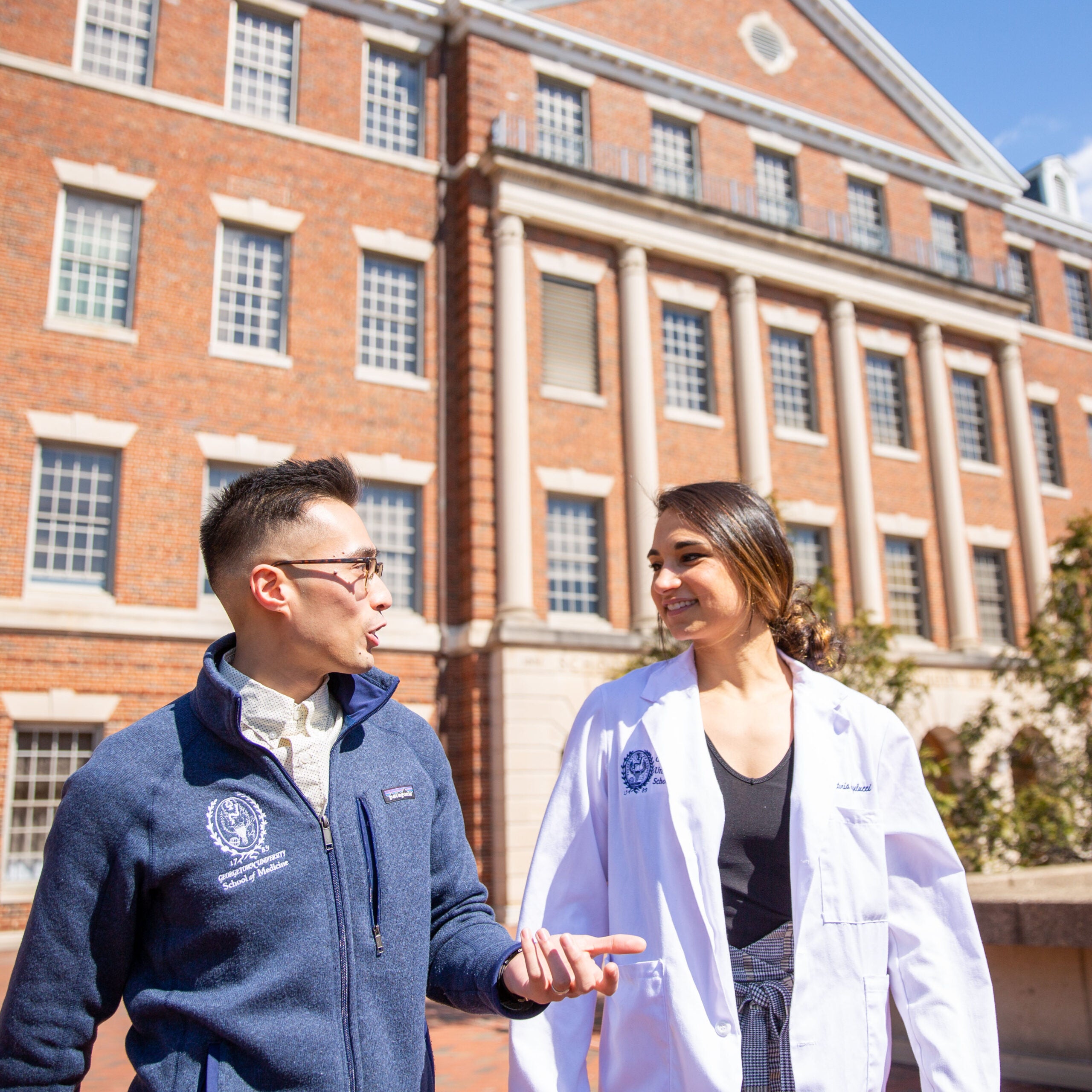 medical students talking in front of medical school building