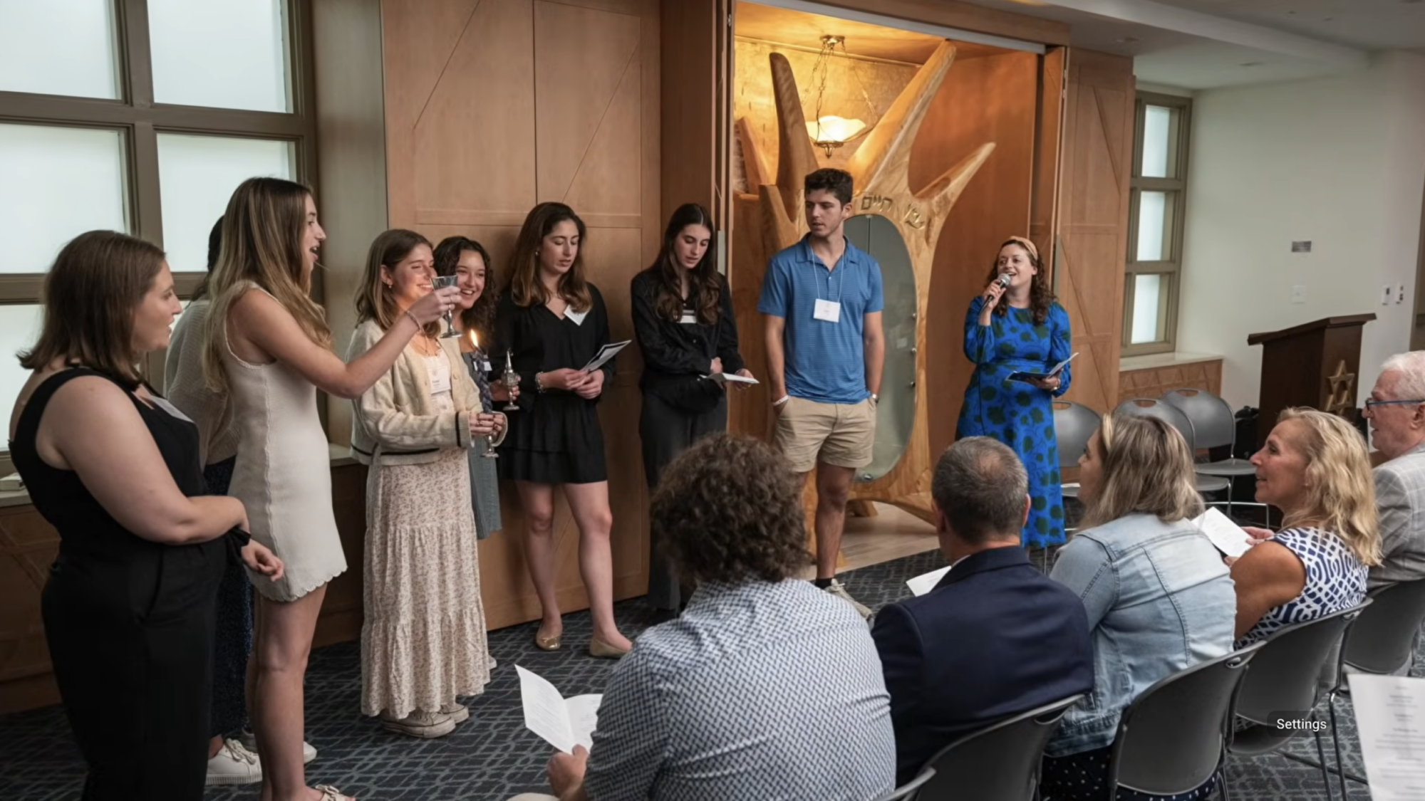 The Wolf family listening to programming at the renovated Makom at Georgetown University