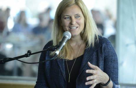 Carrie Walton Penner speaking at a microphone