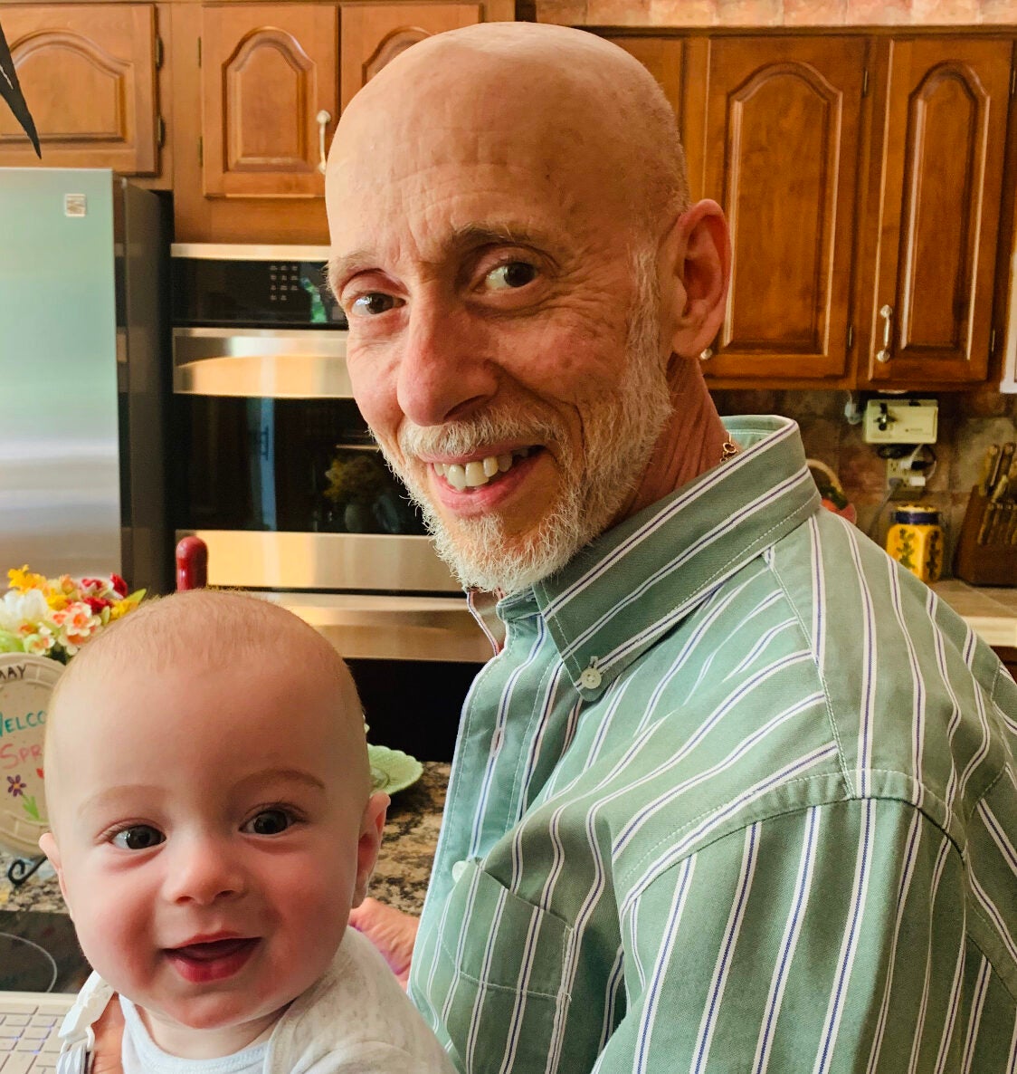 frank smiling with his grandchild