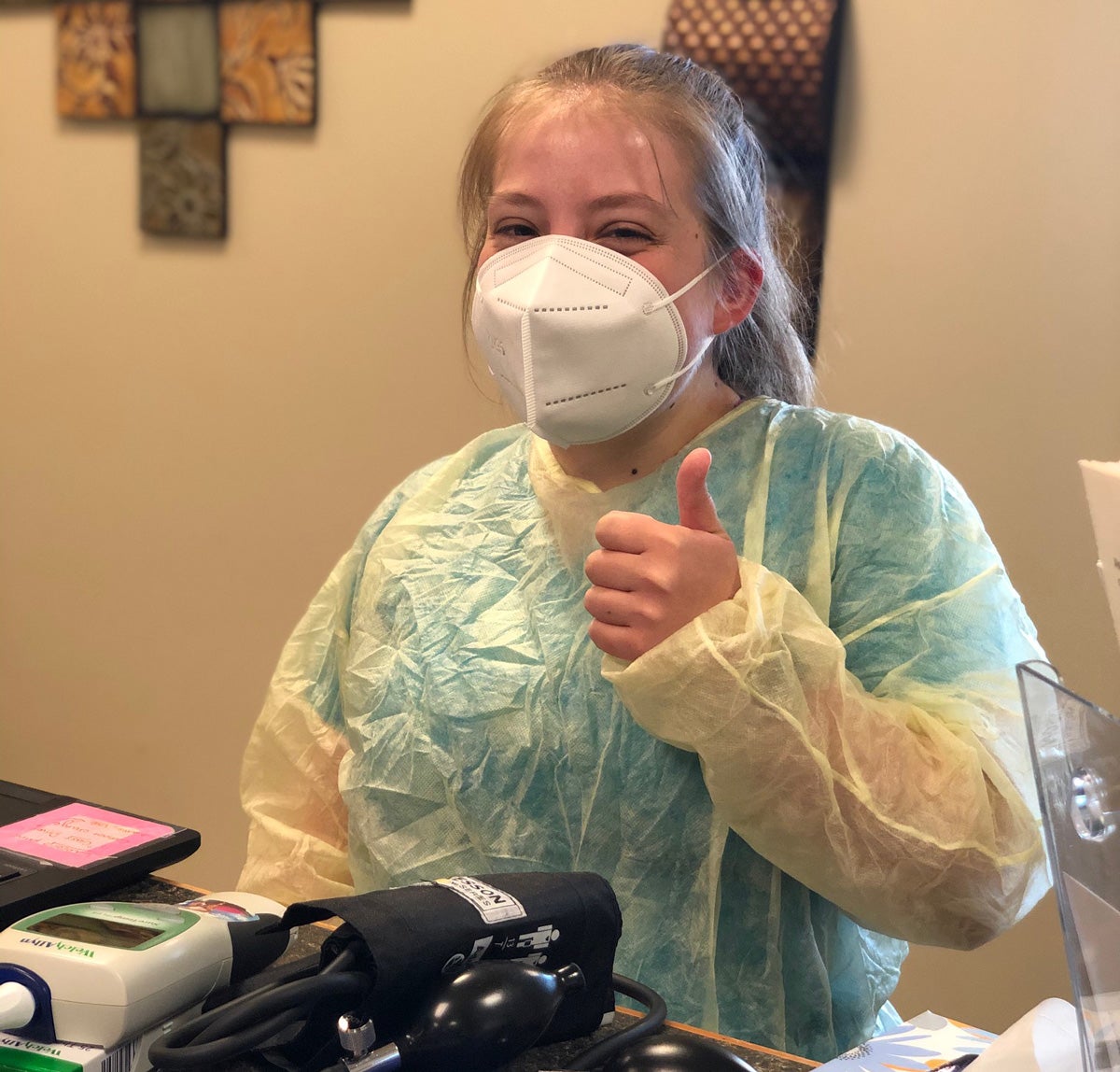 nurse giving thumbs up wearing protective equipment